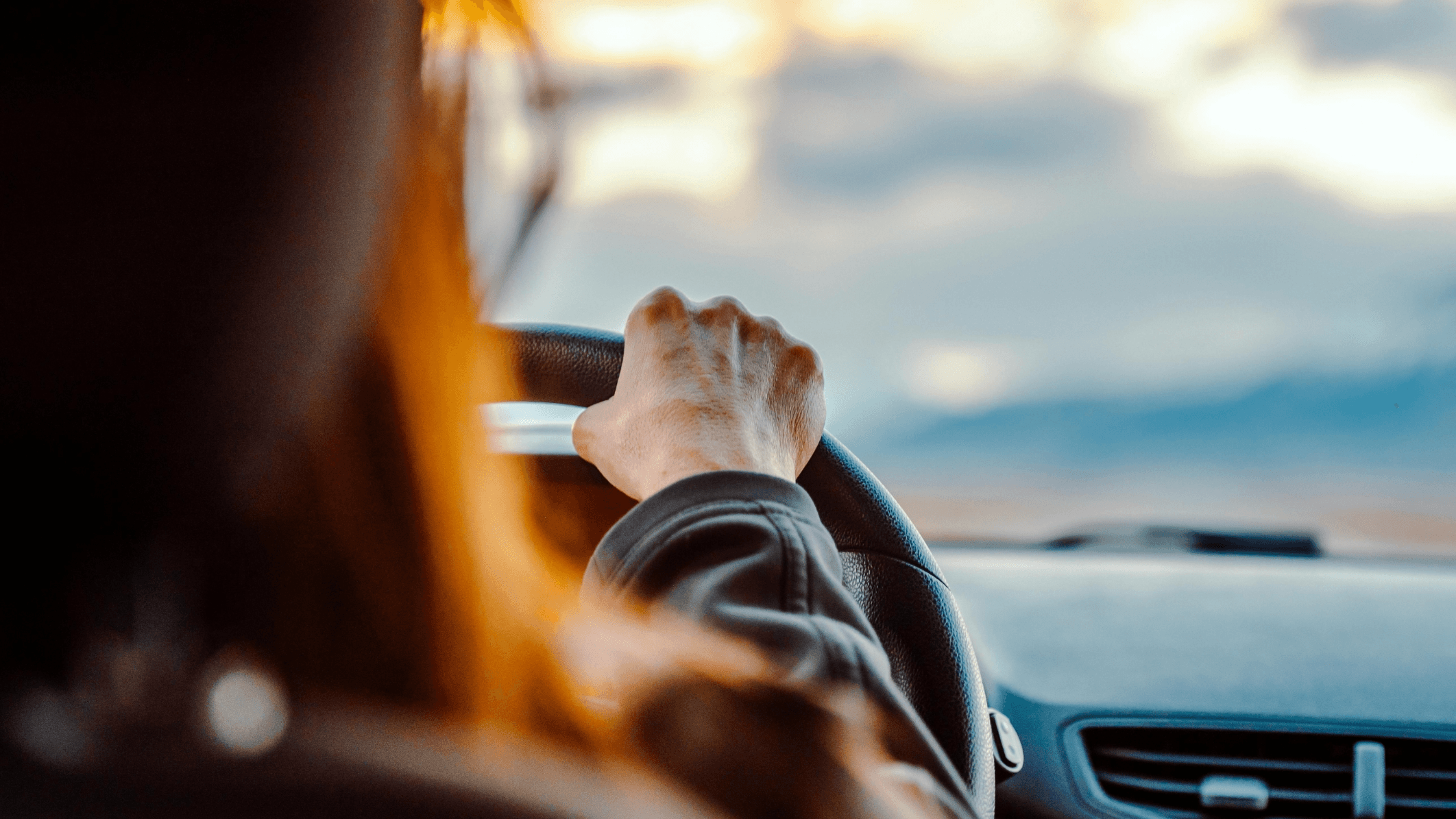 Driver holding a steering wheel